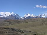 Tibet Kailash 03 Nyalam to Peiku Tso 03 Tong La Mountains As we ascended towards the Tong La (also called Yarle Shang La) from Nyalam, a beautiful mountain panorama unfolded. The Labuche Kang massif is part of the Himalayan range in Tibet, located North-West of Cho Oyu, and half-way between Cho Oyu and Shishapangma. This massif has several summits over 7000m, including the highest Labuche Kang at 7367m (also called Lobuche Kang I or Choksiam) and Labuche Kang II (7072m), both behind the mountain to the left. The broad mountain to the left is 6718m while the mountain partially poking out from behind is 6952m. Note that several websites and Michael Palin�s book Himalaya mistakenly call these mountains Cho Oyu, Menlungtse and Gauri Shankar � they�re not.
